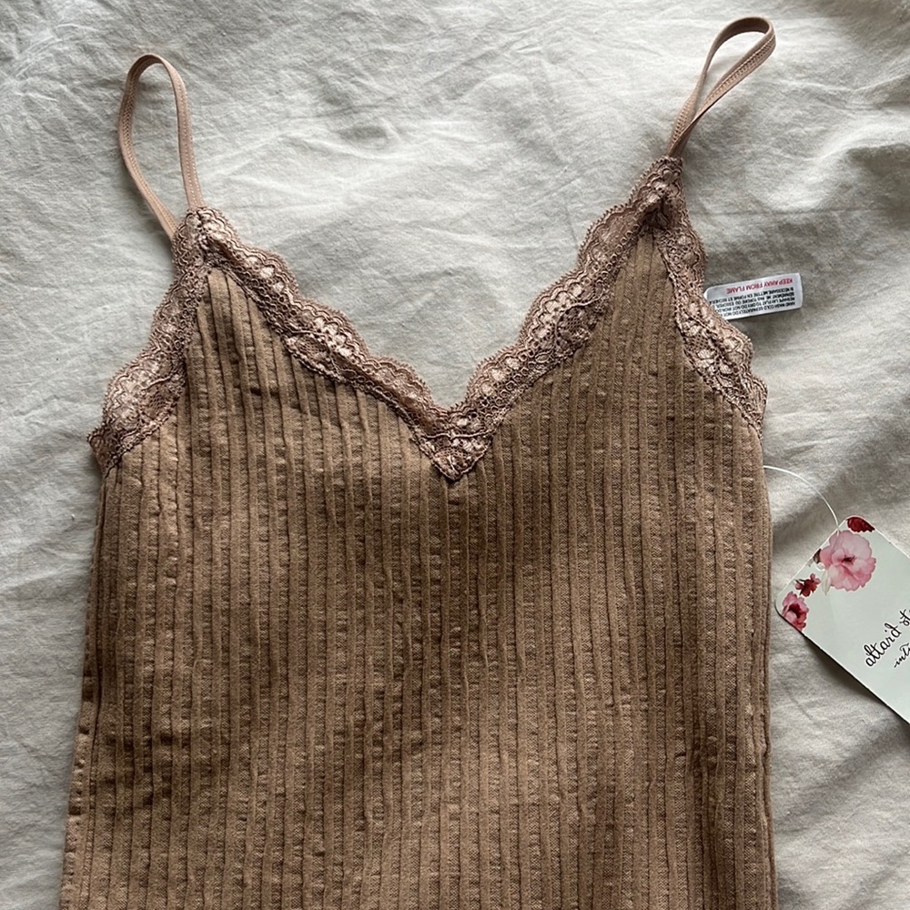 Light brown bodysuit with lacing detail from Altar’d State.